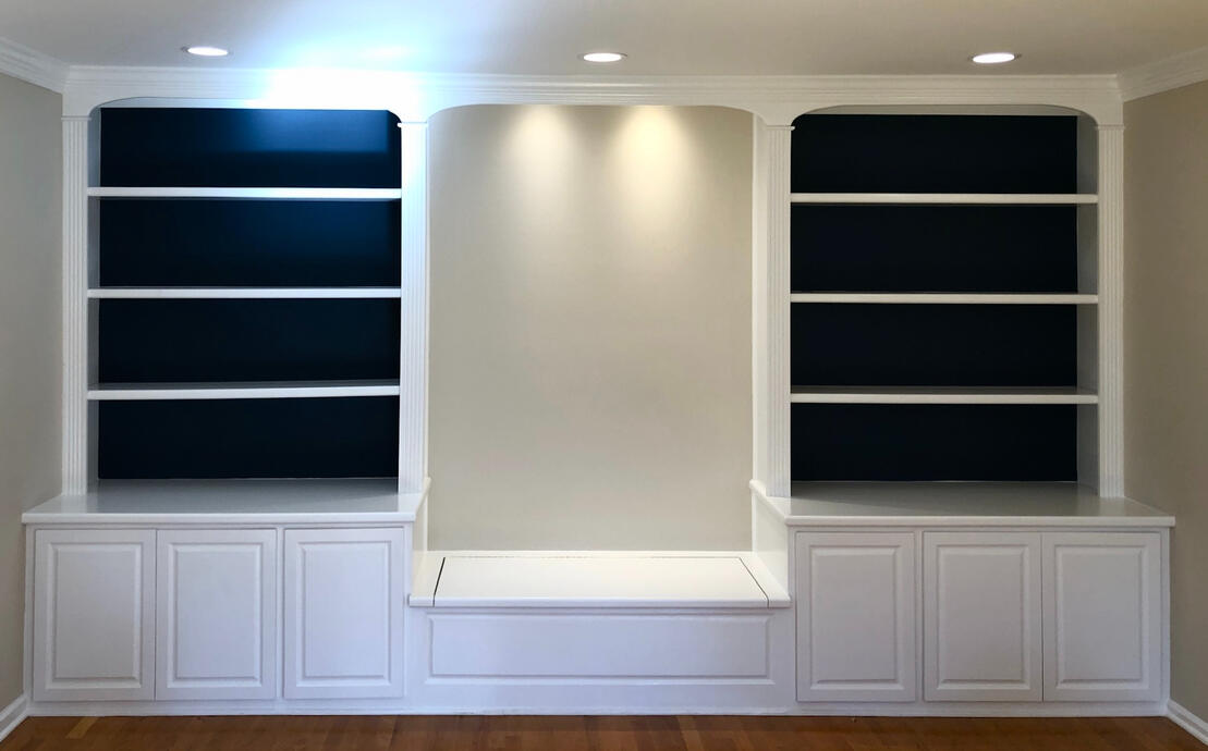 Painted built-in bookcase with navy blue background accent