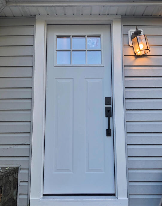 Completed door installation with modern white trimming