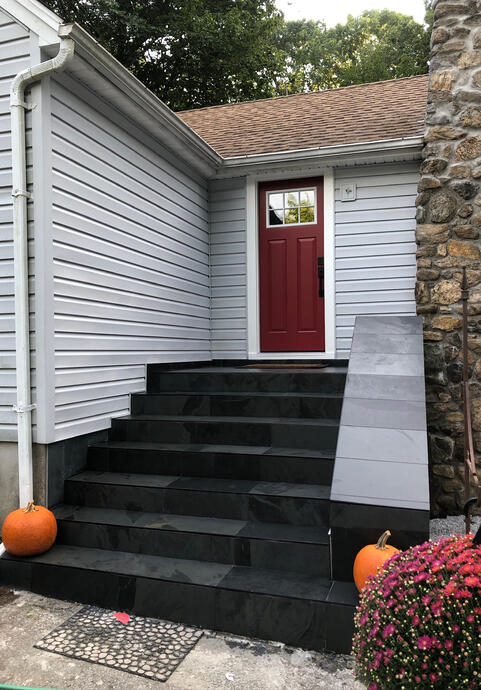 Completed stair and railing with slate tile and trimming