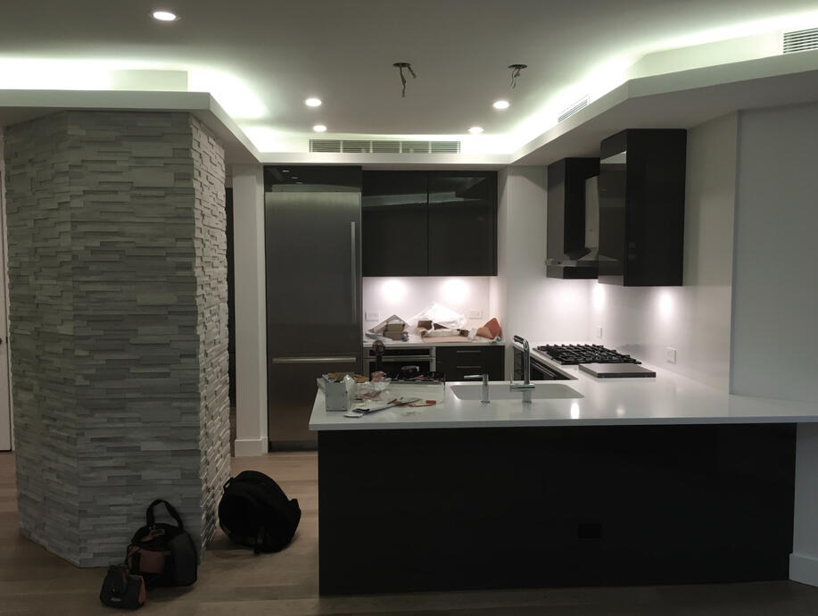 Modern kitchen renovation with custom cove lighting