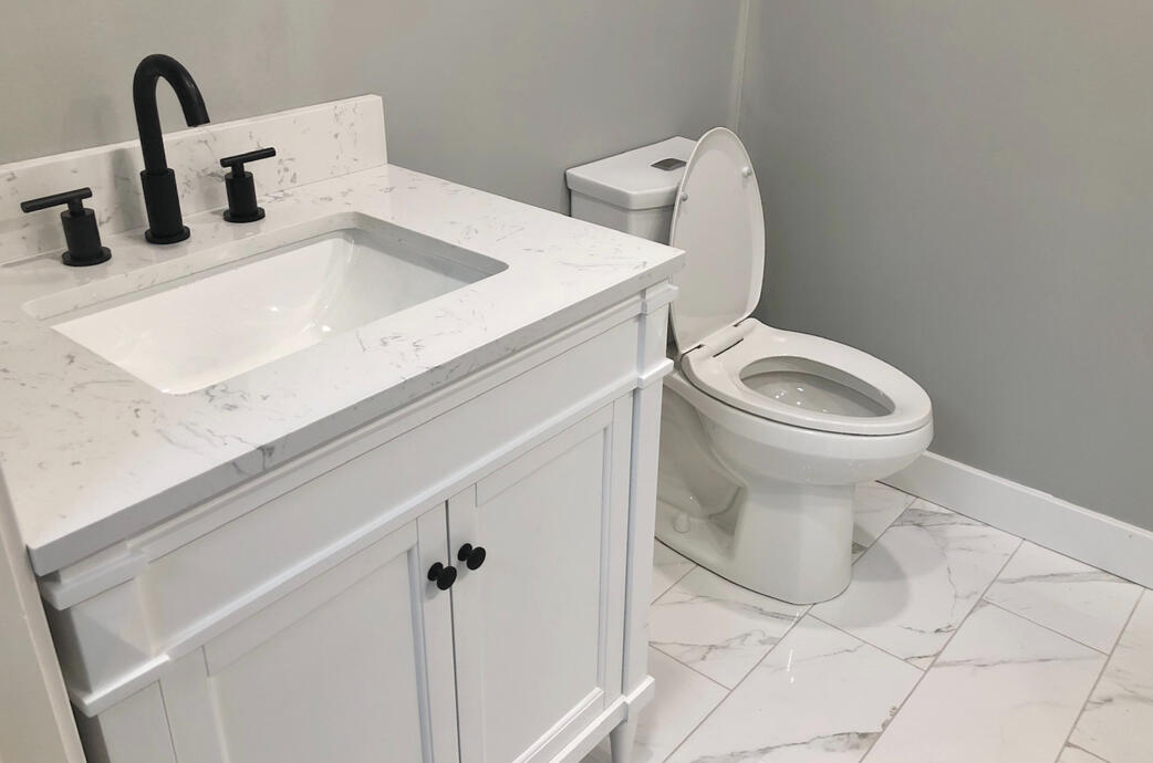 Modern bathroom reno including vanity and toilet installation