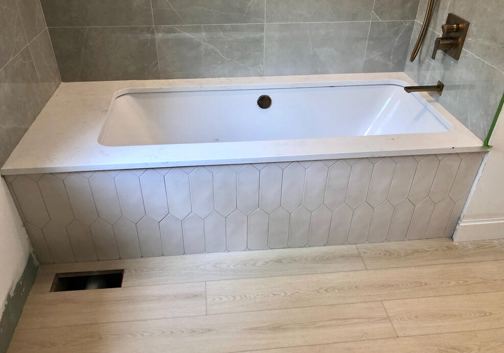 Installation of 72 in. tub and with modern hex tilework